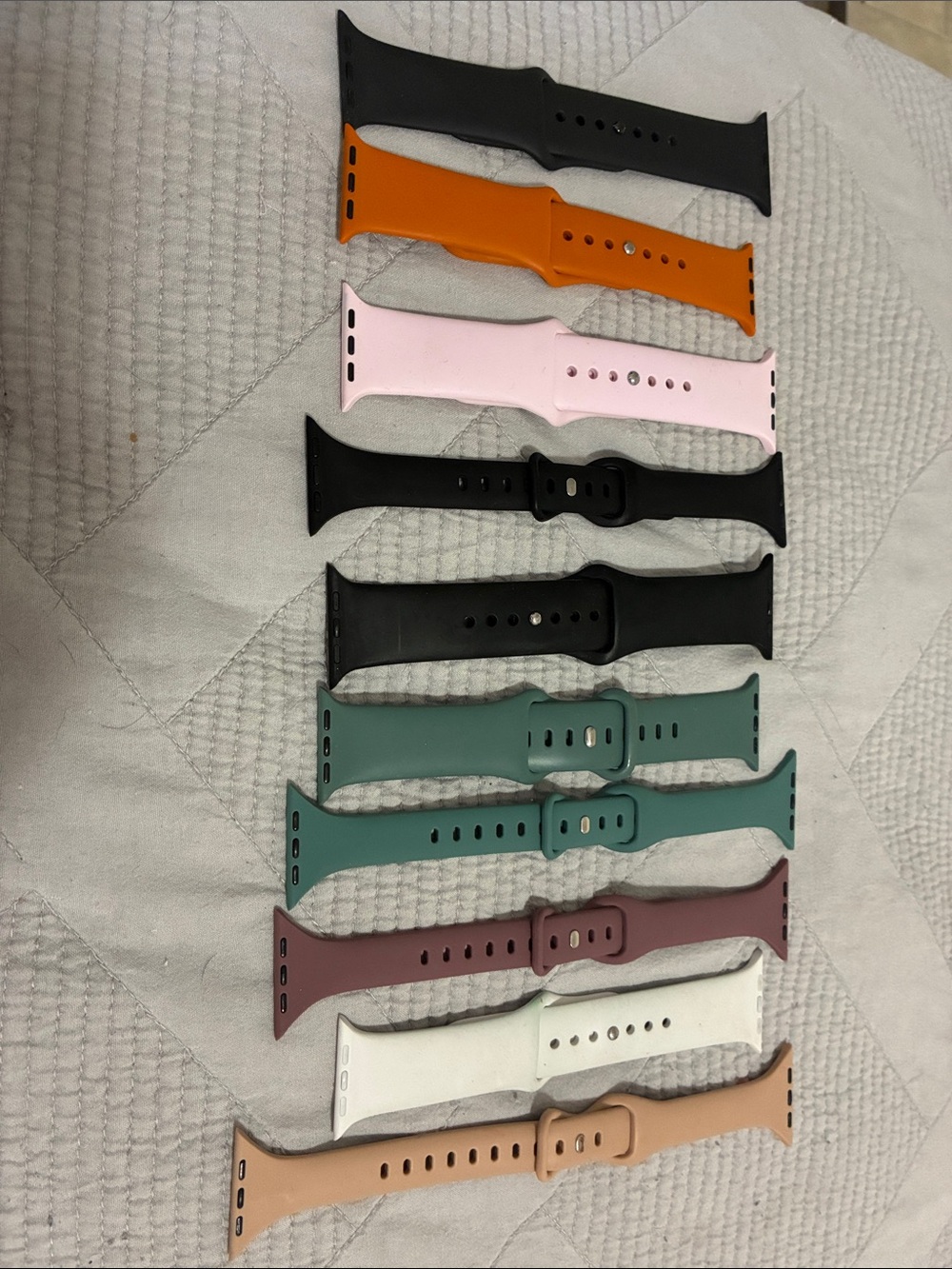 Lot of silicone sport bands for Apple Watch.  Variety of colors.